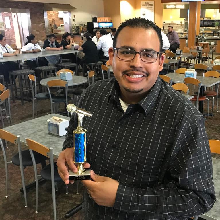 Moses Preciado holding his award. 